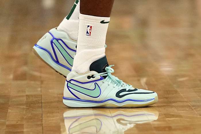 Milwaukee Bucks forward Khris Middleton's teal and black Nike sneakers.